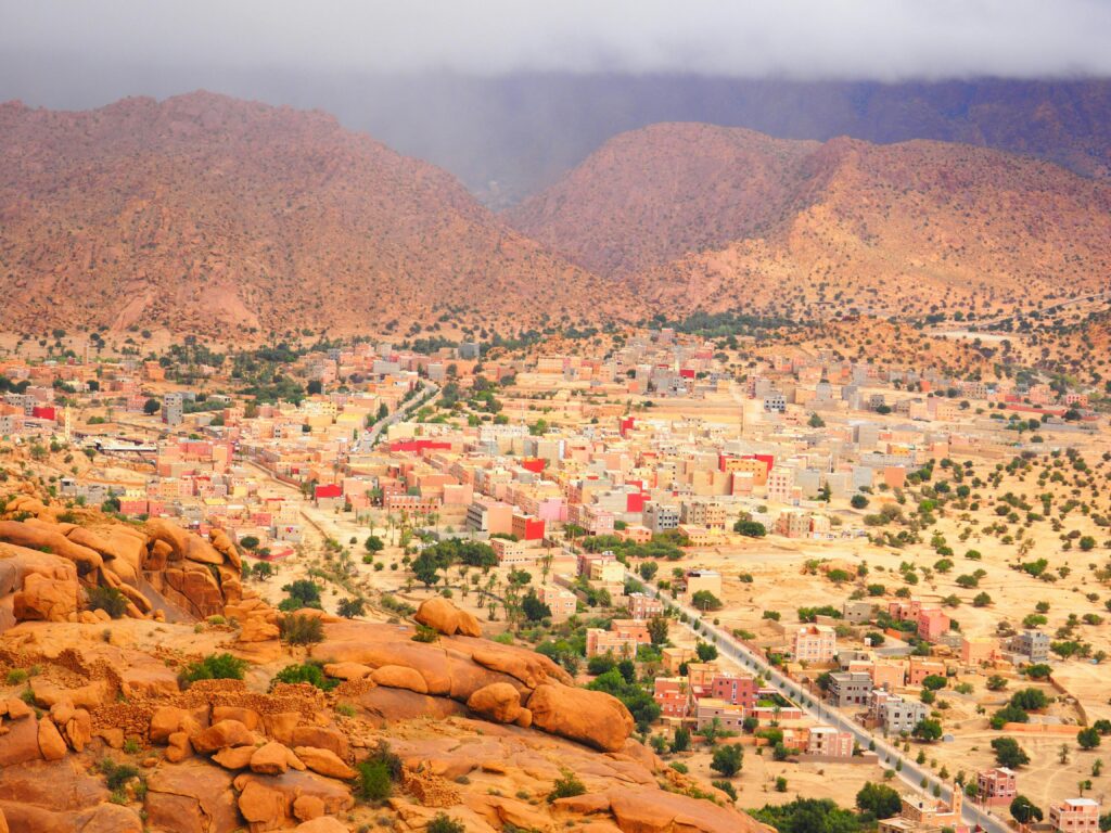 A stunning aerial view of Tafraoute village in Morocco surrounded by arid landscapes and rugged mountains.